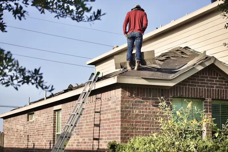 Professional roofer working on a residential roof in Moreland